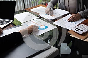 Professional businesswoman, entrepreneur or accountant working on a financial report paperwork at her desk, using laptop