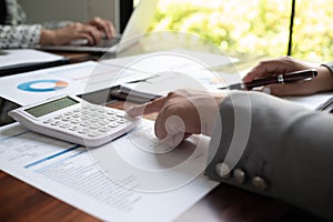 Professional businesswoman, entrepreneur or accountant working on a financial report paperwork at her desk, using laptop