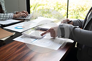 Professional businesswoman, entrepreneur or accountant working on a financial report paperwork at her desk, using laptop