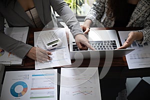 Professional businesswoman, entrepreneur or accountant working on a financial report paperwork at her desk, using laptop