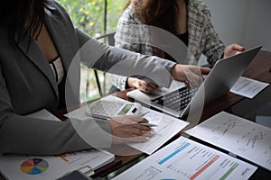 Professional businesswoman, entrepreneur or accountant working on a financial report paperwork at her desk, using laptop