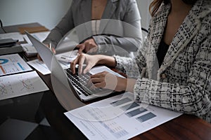 Professional businesswoman, entrepreneur or accountant working on a financial report paperwork at her desk, using laptop