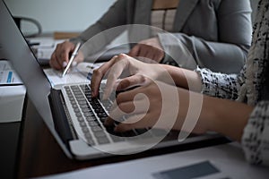 Professional businesswoman, entrepreneur or accountant working on a financial report paperwork at her desk, using laptop