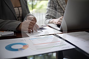 Professional businesswoman, entrepreneur or accountant working on a financial report paperwork at her desk, using laptop