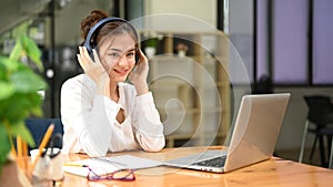 Professional businesswoman using laptop and working with document on office desk