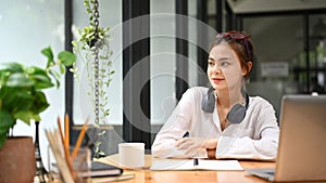 Professional businesswoman using laptop and working with document on office desk