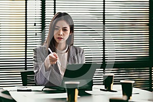 Professional businesswoman using laptop and working with document on office desk