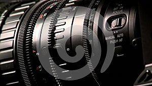 Professional camcorder lens on dark background, macro