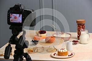 Professional camera and composition with delicious desserts on table in photo studio. Food photography