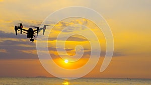 Professional camera drone flying on sea.