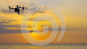 Professional camera drone flying on sea.