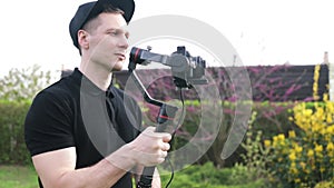 Professional camera man creating video content outdoors. Filmmaker Working outdoors.