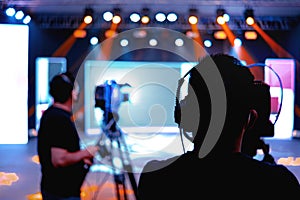 Professional cameraman - covering on event with a video, cameraman silhouette on live studio news, Selective focus