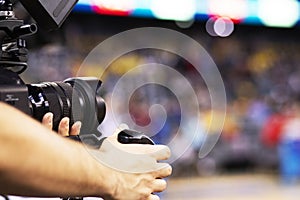 professional cameraman recording sporting event