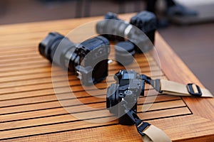 Professional cameras on wooden table