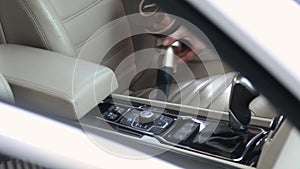 Professional car interior cleaning. detailing. vacuuming the seats and floor in a luxury sedan.