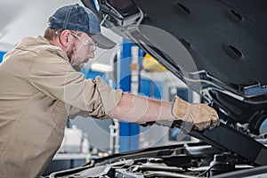Professional Car Mechanic Performing Modern Vehicle Maintenance