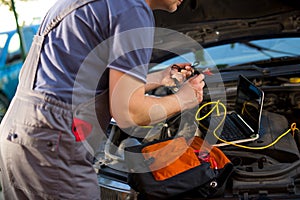 Professional car mechanic working in auto repair service