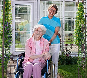 Professional carer behind happy elderly woman