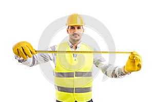 Professional carpenter or engineer holding measuring tape