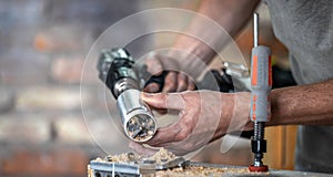 Professional carpenter working with a hinge drill, working with wood