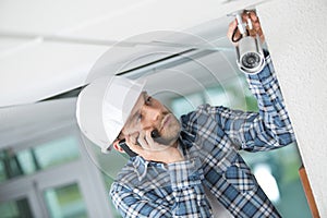 Professional cctv technician using phone