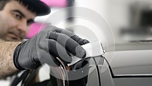 Professional ceramics handler apply different layers to the car using an applicator sponge, fiber immediately checking the effec