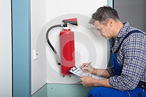 Professional Checking A Fire Extinguisher