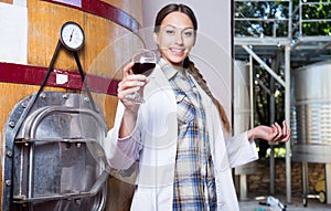 Professional checks the wine at factory in France