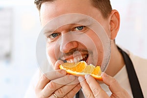 Professional Chef Bite Orange Slice Portrait