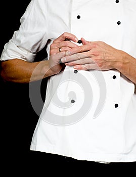Professional chef buttoning up a white chefs jacket