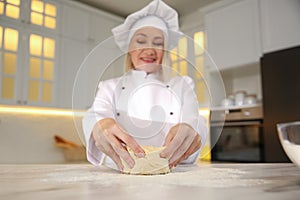 Professional chef cooking dough at table, focus on hands