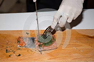 Professional chef cutting smoke salmon prepare for customer appetizer