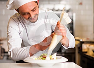 Professional chef decorating the dish