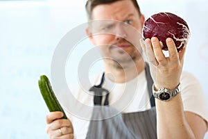 Professional Chef Holding Whole Purple Cabbage photo