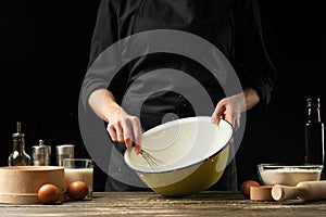 Professional chef prepares the dough for bread, Italian pizza, pies, pasta, Amerekan pancakes, Russian pancakes and sweets.