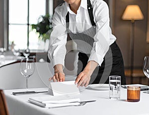 Professional Chef Preparing Table Setting in Restaurant