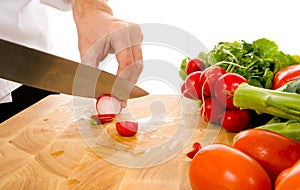 Professional chef slicing radish photo