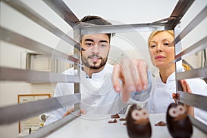 professional chefs looking at little novelyty chocolate hats