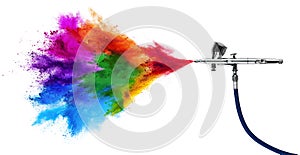 Professional chrome metal airbrush acrylic color paint gun tool with colorful rainbow spray holi powder cloud explosion isolated