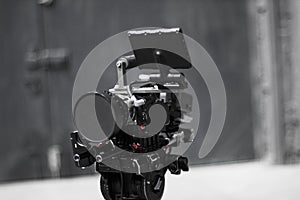 Professional cinema digital video camera on a tripod.