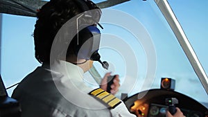 Professional civil aviation pilot passing flight details to controller via radio
