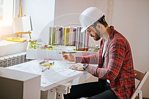 Professional civil engineer working with documents, drawings in office