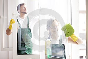 Professional cleaners cleaning windows