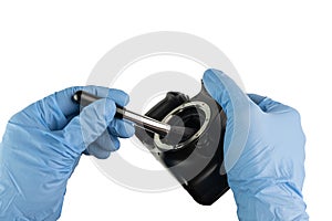 Professional cleaning of a camera housing with a bellows and gloves