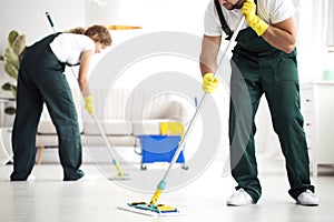 Professional cleaning crew washing floor photo