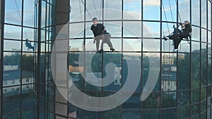 Professional climbers are working in front of business center