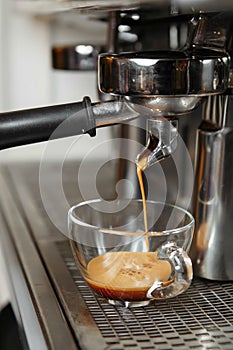 Professional coffee machine making espresso in a cafe