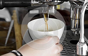 Professional coffee machine making espresso in a cafe, close-up