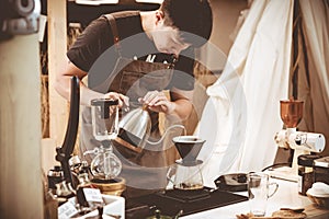 Professional coffee maker - Barista using coffee siphon brewing hot espresso at coffee shop